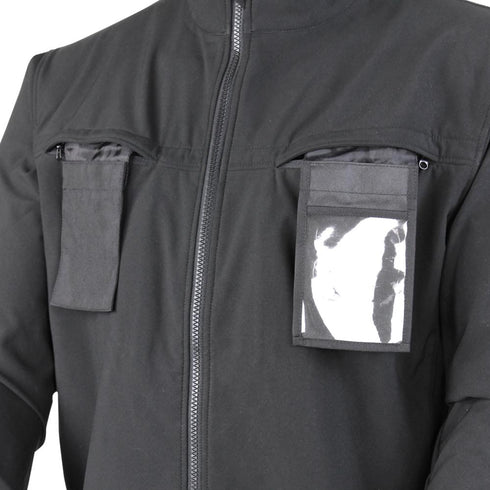 A close-up of the Condor Covert Softshell Jacket | SALE, a black EDC jacket with two chest pockets—one with a flap, the other featuring a transparent window showing a partially visible card.