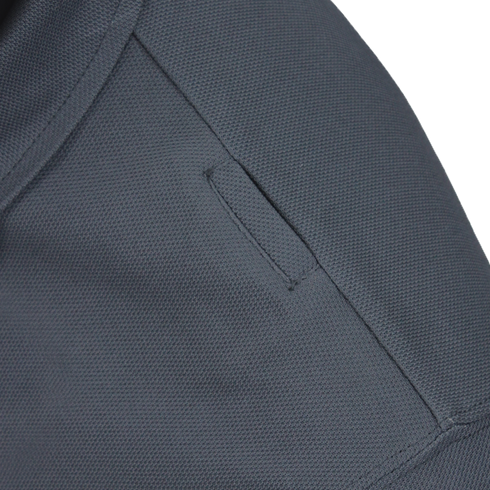 Close-up of the Condor Short Sleeve Performance Tactical Polo in dark gray, highlighting the textured fabric and a small, neatly sewn slit pocket with parallel stitching along the pocket opening.