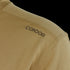 Close-up of a tan textured Maxfort Short Sleeve Training Top by Condor, featuring CONDOR printed in black near the shoulder—ideal for EDC or bushcraft activities.