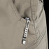 A metal pen with a clip is secured in the front pocket of Condor Scout Shorts in light brown, ready for use by a first responder.