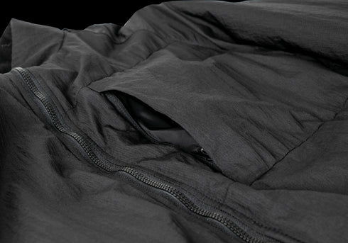 Close-up of the Condor Nimbus Light Loft Jacket in black, showing a partially open pocket and a visible zipper. On SALE.