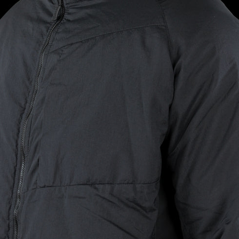 Close-up of the Condor Nimbus Light Loft Jacket (SALE), a black tactical puffer with visible zipper and quilted stitching, shown on an unidentified person.