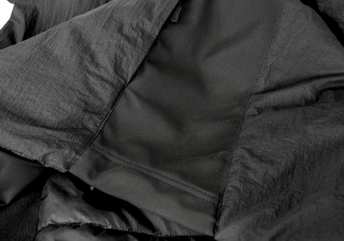 Close-up of the inside lining and stitching of the Condor Nimbus Light Loft Jacket | SALE in black, highlighting its smooth and textured fabric sections with visible seams.