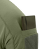 A green notebook is partially tucked into the sleeve pocket of the Condor Trident Short Sleeve Battle Top in olive green.