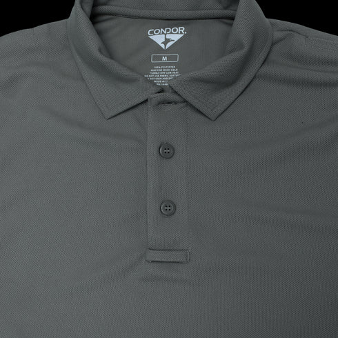 A close-up of a dark gray Condor Long Sleeve Performance Tactical Polo with three buttons, collar, and visible size and care label—perfect apparel for law enforcement or first responders.