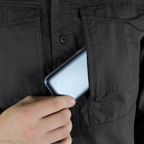 A person places a smartphone into the chest pocket of the Condor Tac-Pro Shirt | SALE.