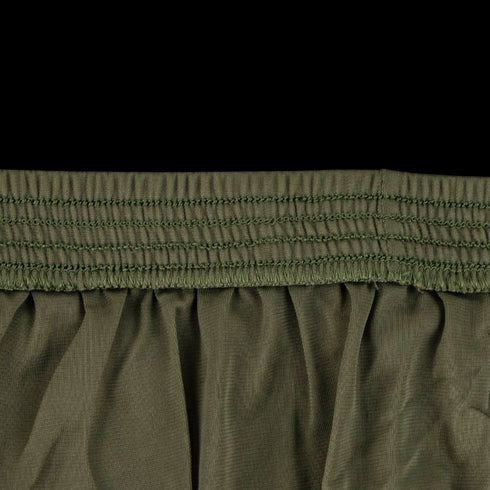 Close-up of olive green Condor Running Shorts fabric with multiple rows of stitching and gathered pleats, featuring a tactical elastic waistband ideal for active use.