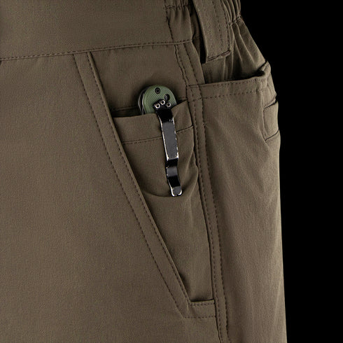 A close-up of a green folding knife, a must-have EDC tool, clipped to the front pocket of Condor Maverick Shorts.