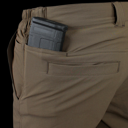 A close-up of Condors Maverick Shorts in brown, featuring a black magazine partially tucked into the back pocket—ideal for EDC enthusiasts.