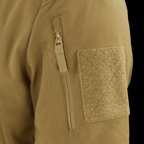 Close-up of the Condor Westpac Softshell Jackets tan sleeve, highlighting a vertical zipper pocket and a large rectangular hook-and-loop patch.