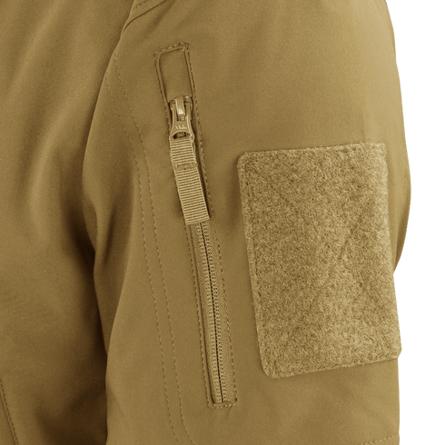 Close-up of the Condor Westpac Softshell Jackets tan sleeve, highlighting a vertical zipper pocket and a large rectangular hook-and-loop patch.