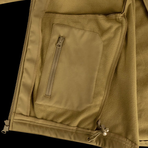 Close-up of the Condor Westpac Softshell Jacket in tan, featuring a zippered interior pocket and adjustable drawstring hem, designed for first responders.