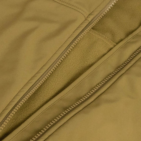 Close-up of the Condor Westpac Softshell Jacket in tan, featuring a partially unzipped zipper that reveals a soft fleece lining inside.