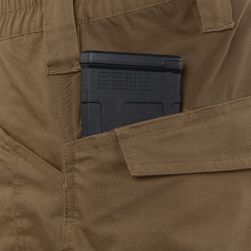 A black magazine is partially visible in the side pocket of tan Condor Paladin Tactical Pants.