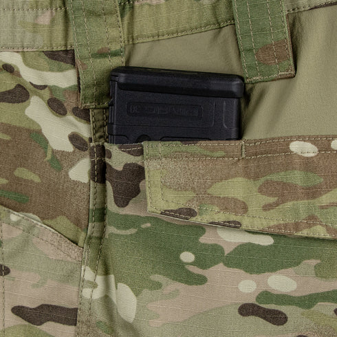 A black rifle magazine is partially visible in the front pocket of Condor Paladin Tactical Pants in MultiCam.