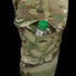 A clear plastic water bottle with a green cap is partially visible in the side pocket of Condors Paladin Tactical Pants in MultiCam.