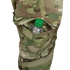 A clear plastic water bottle with a green cap is partially visible in the side pocket of Condors Paladin Tactical Pants in MultiCam.