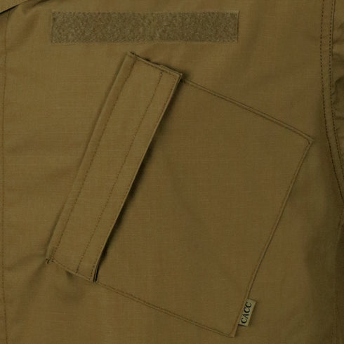 Close-up of the Condor Cadet Class C Uniform Coat, a brown tactical jacket highlighted by a large slanted front pocket with a flap and a small fabric tag.