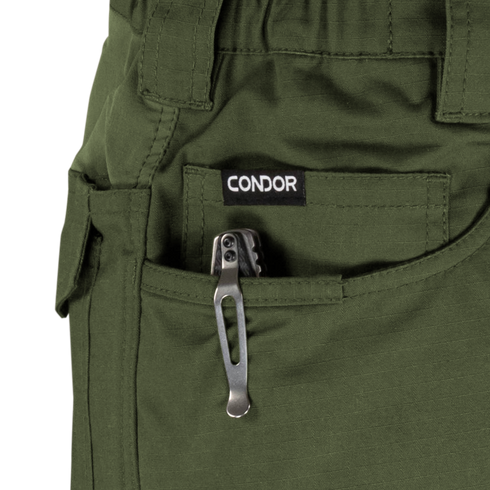 A tactical multitool with a metal pocket clip is partially visible in the front pocket of green Condor Odyssey Pants Gen III.