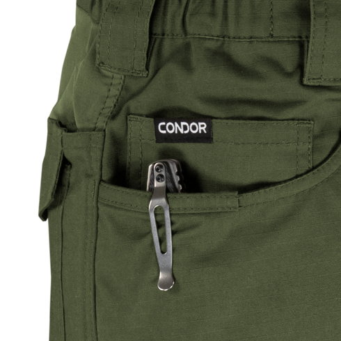 A tactical multitool with a metal pocket clip is partially visible in the front pocket of green Condor Odyssey Pants Gen III.