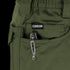 A tactical multitool with a metal pocket clip is partially visible in the front pocket of green Condor Odyssey Pants Gen III.