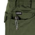 A tactical multitool with a metal pocket clip is partially visible in the front pocket of green Condor Odyssey Pants Gen III.