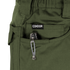 A tactical multitool with a metal pocket clip is partially visible in the front pocket of green Condor Odyssey Pants Gen III.