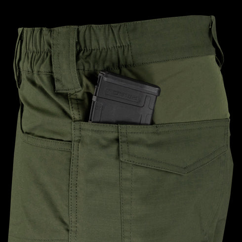 A close-up of Condor Odyssey Pants Gen III in olive green, featuring a black rifle magazine partially visible in the side pocket.