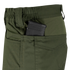 A close-up of Condor Odyssey Pants Gen III in olive green, featuring a black rifle magazine partially visible in the side pocket.
