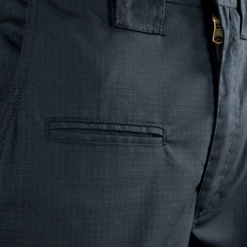 Close-up view of the front pocket and zipper area of Condor Women's Protector EMS Pants, featuring a dark color and subtle grid pattern.