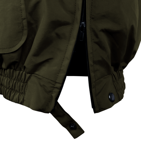 Close-up of the Condor Guardian Duty Jacket in olive green, featuring a partially open zipper at the bottom, elasticized hem, and a buttoned strap detail.