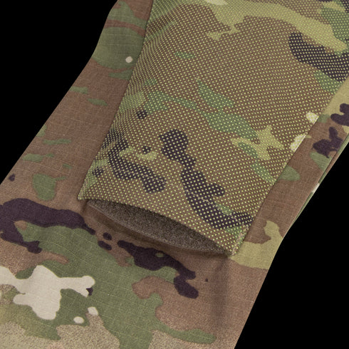 Close-up of the Condor Long Sleeve Combat Shirt Gen II in MultiCam, showing digital-patterned fabric with green, brown, and tan tones and a folded edge.