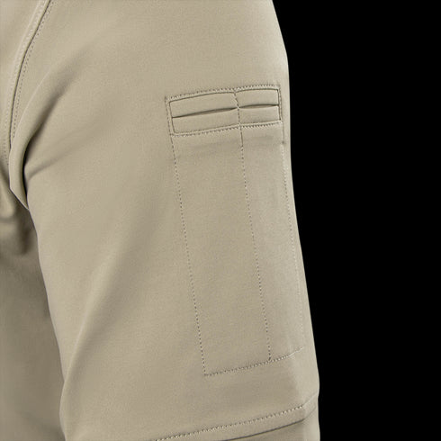 Close-up of the Condor Short Sleeve Dri-Flex Tactical Polo's tan sleeve, highlighting a rectangular patch pocket with two horizontal stitched lines at the top.