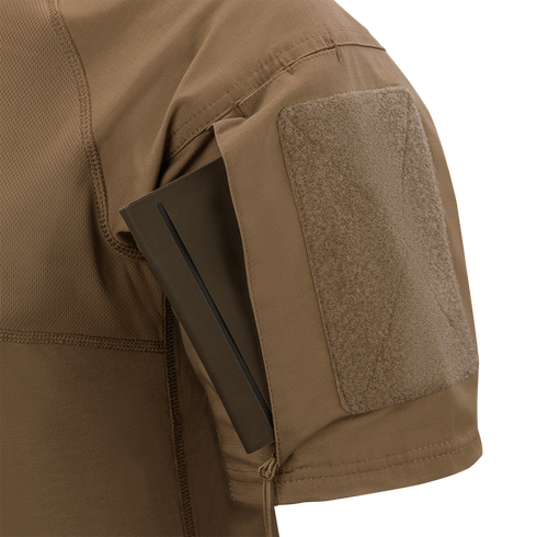 A close-up of the Condor Short Sleeve Combat Shirt Gen II in brown shows its lightweight sleeve with a rectangular pocket holding a slim, dark item partially inserted.