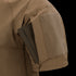 A close-up of the Condor Short Sleeve Combat Shirt Gen II in brown shows its lightweight sleeve with a rectangular pocket holding a slim, dark item partially inserted.