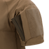 A close-up of the Condor Short Sleeve Combat Shirt Gen II in brown shows its lightweight sleeve with a rectangular pocket holding a slim, dark item partially inserted.