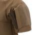 A close-up of the Condor Short Sleeve Combat Shirt Gen II in brown shows its lightweight sleeve with a rectangular pocket holding a slim, dark item partially inserted.