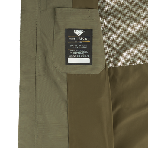 Close-up of the interior of an olive-green Condor Aegis Waterproof Parka featuring a branded label with care instructions attached to a fabric pocket.