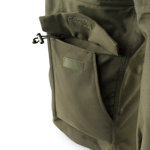 Close-up of the Condor Aegis Waterproof Parka’s olive green pocket featuring a flap closure and drawstring toggle.
