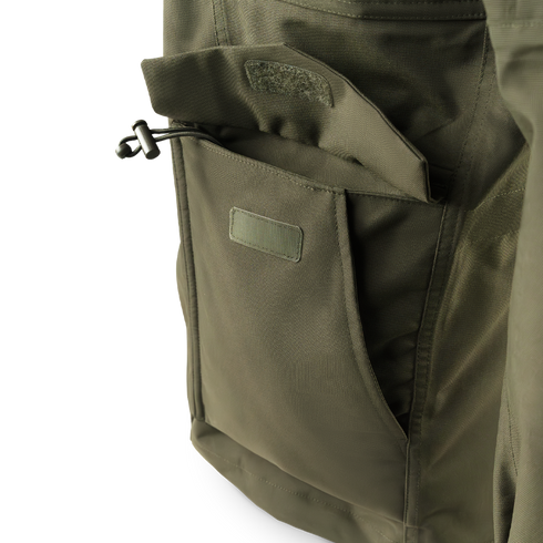 Close-up of the Condor Aegis Waterproof Parka’s olive green pocket featuring a flap closure and drawstring toggle.