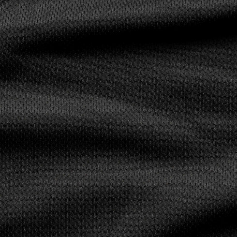 Close-up of the Condor Trident Sun Shirt’s black textured fabric, featuring subtle horizontal folds and a fine, slightly raised pattern.