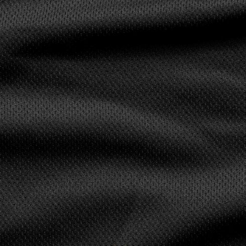 Close-up of the Condor Trident Sun Shirt’s black textured fabric, featuring subtle horizontal folds and a fine, slightly raised pattern.