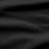 Close-up of the Condor Trident Sun Shirt’s black textured fabric, featuring subtle horizontal folds and a fine, slightly raised pattern.