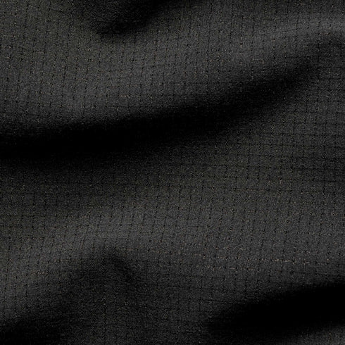 Close-up of the Condor Trident Sun Shirt’s black ripstop fabric, featuring a grid pattern and subtle texture with gentle folds.