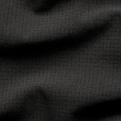 Close-up of the Condor Trident Sun Shirt’s black ripstop fabric, featuring a grid pattern and subtle texture with gentle folds.