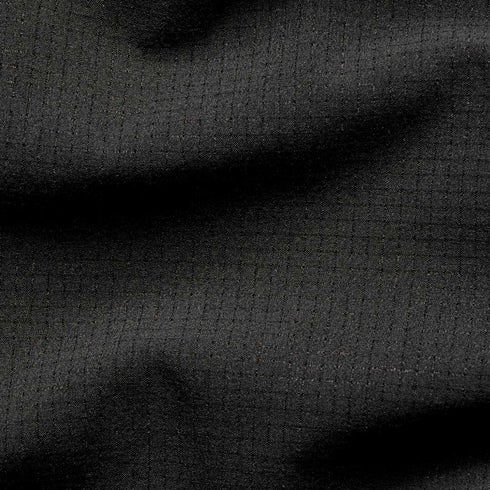 Close-up of the Condor Trident Sun Shirt’s black ripstop fabric, featuring a grid pattern and subtle texture with gentle folds.