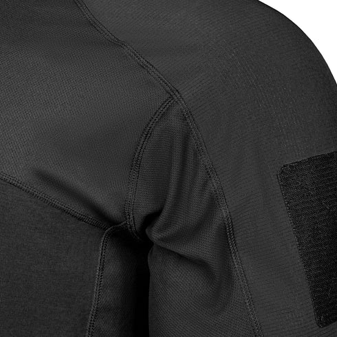 Close-up of the shoulder and upper sleeve of the Condor Trident Sun Shirt, a black textured long-sleeve garment with visible stitching and a contrasting patch on the upper arm.