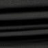 Close-up of the Condor Trident Sun Shirt reveals its layered, ribbed black fabric with horizontal folds and fine texture.