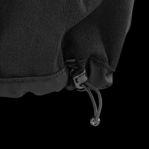 Close-up of the hem of the Condor Core Softshell Vest, a black fleece garment with an adjustable drawstring and plastic toggle—perfect for EDC or bushcraft use.