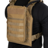 Person wearing the Condor Tidepool Hydration Carrier—a tan vest with zippered front pouch and MOLLE webbing—over a black long-sleeve shirt; perfect for bushcraft or range use.